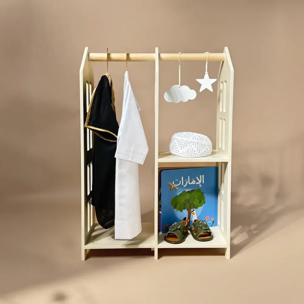 Baby boy gift stand with bisht, kandura, kufi cap, UAE book and sandals on shelves