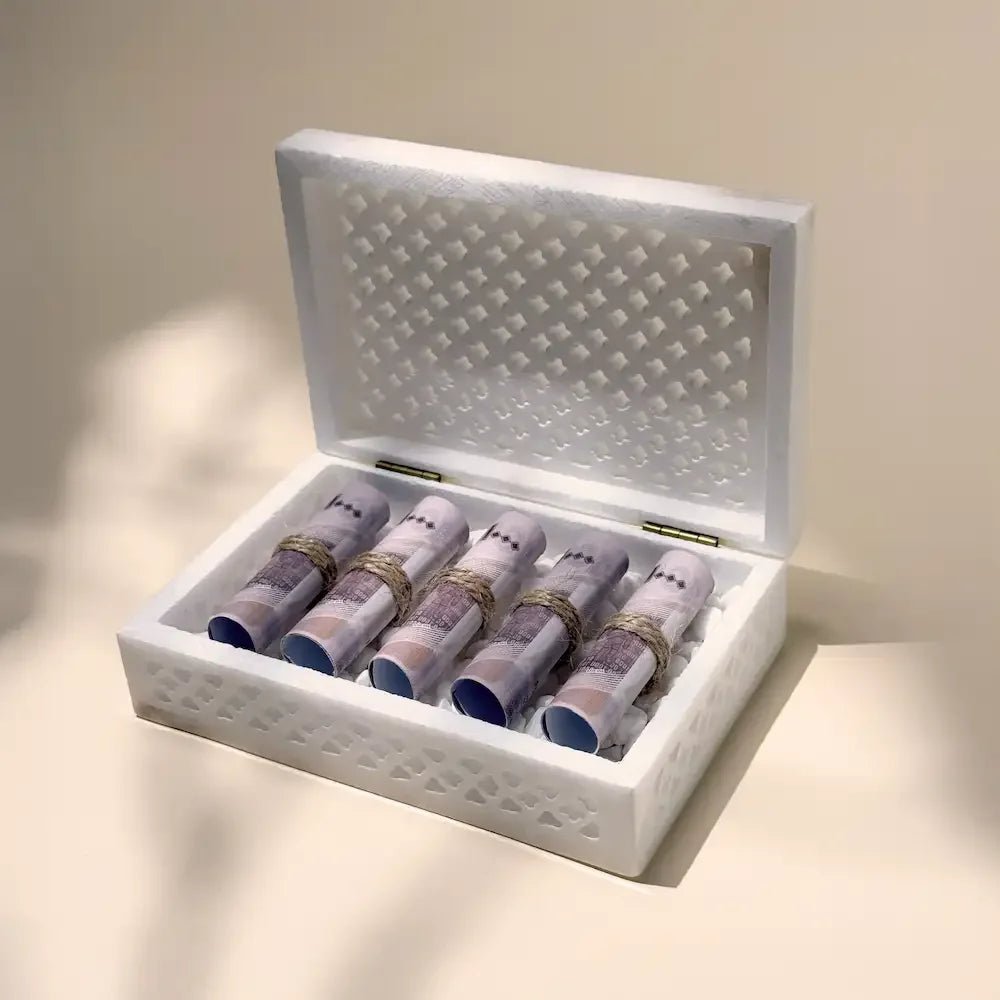 Open cutout marble gift box revealing rolled cash arrangement, angled view