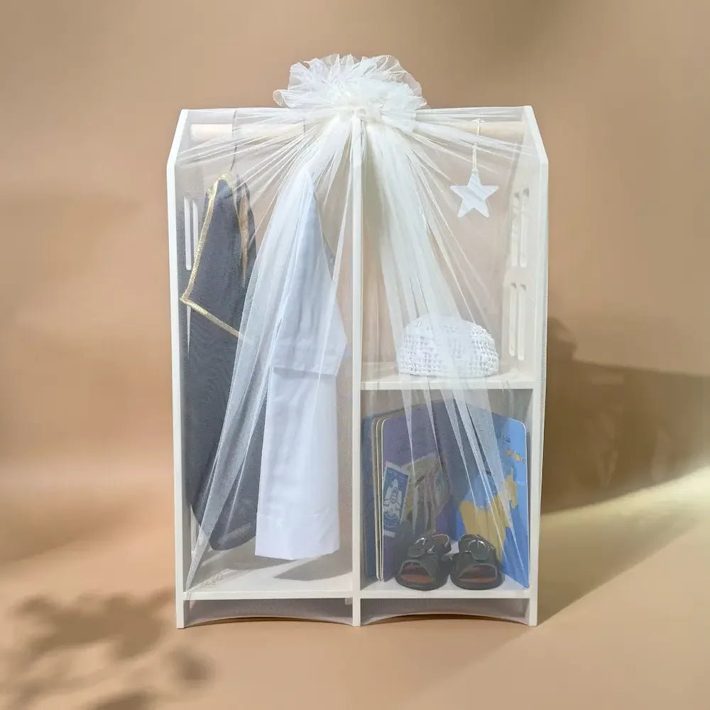 Traditional baby boy outfit set wrapped in sheer tulle on wooden hanger stand