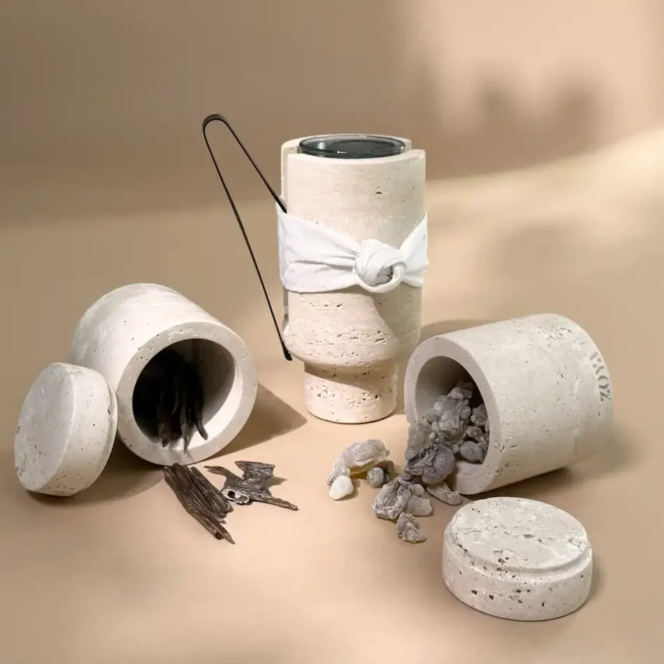 Open travertine oud burner and storage canisters showing oud chips and bakhoor