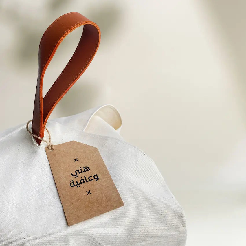 Close-up of leather loop handle and kraft tag on cotton food wrap