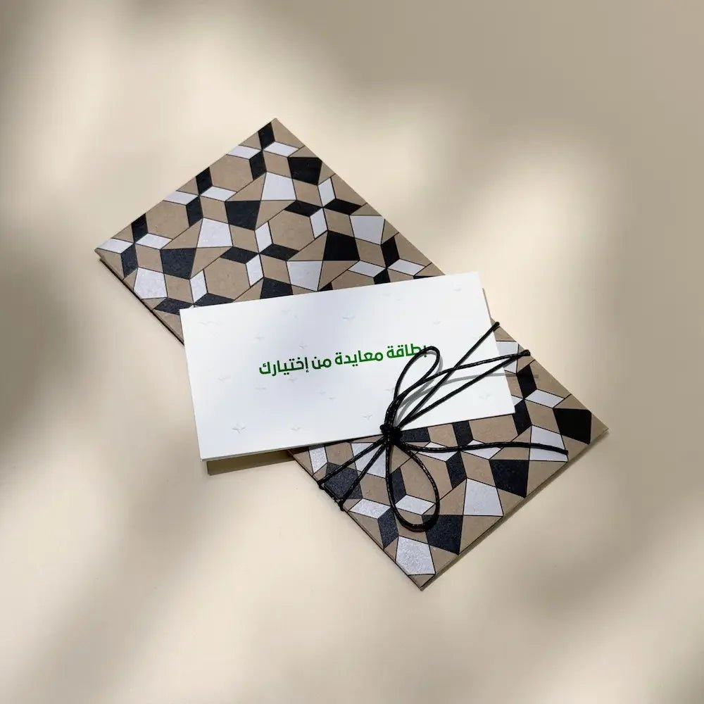 Geometric cash envelope tied with black cord, paired with a blank greeting card