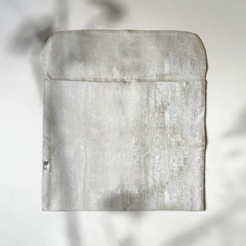 Gold fabric pouch laid flat showing fold-over flap and Maska label