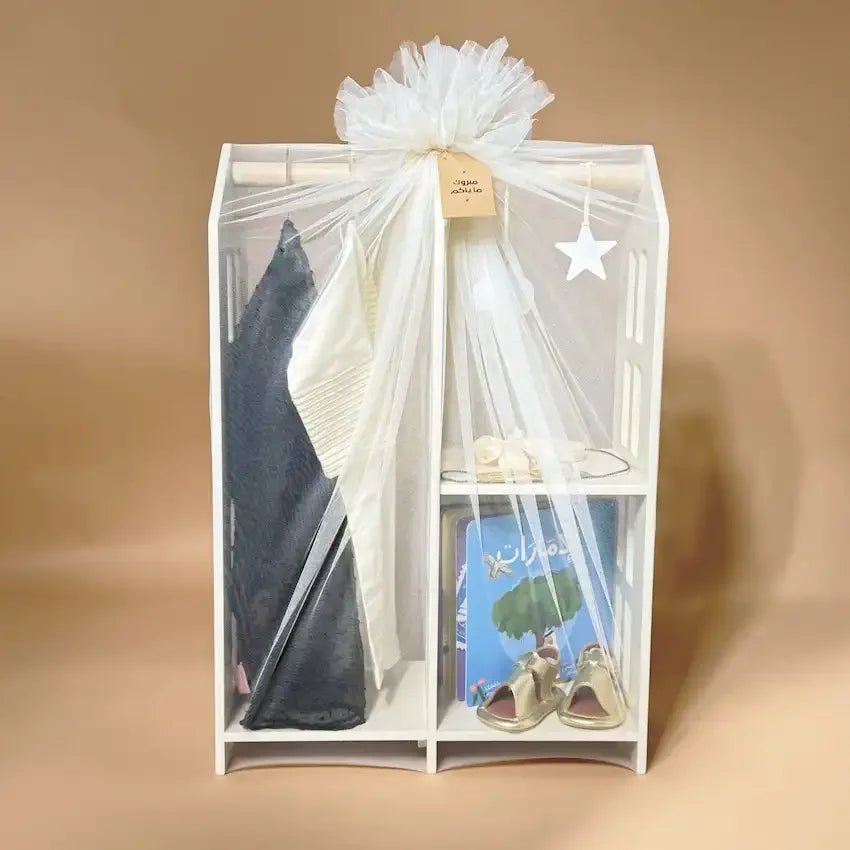 Gift stand wrapped in soft tulle with bow, ready for newborn girl presentation