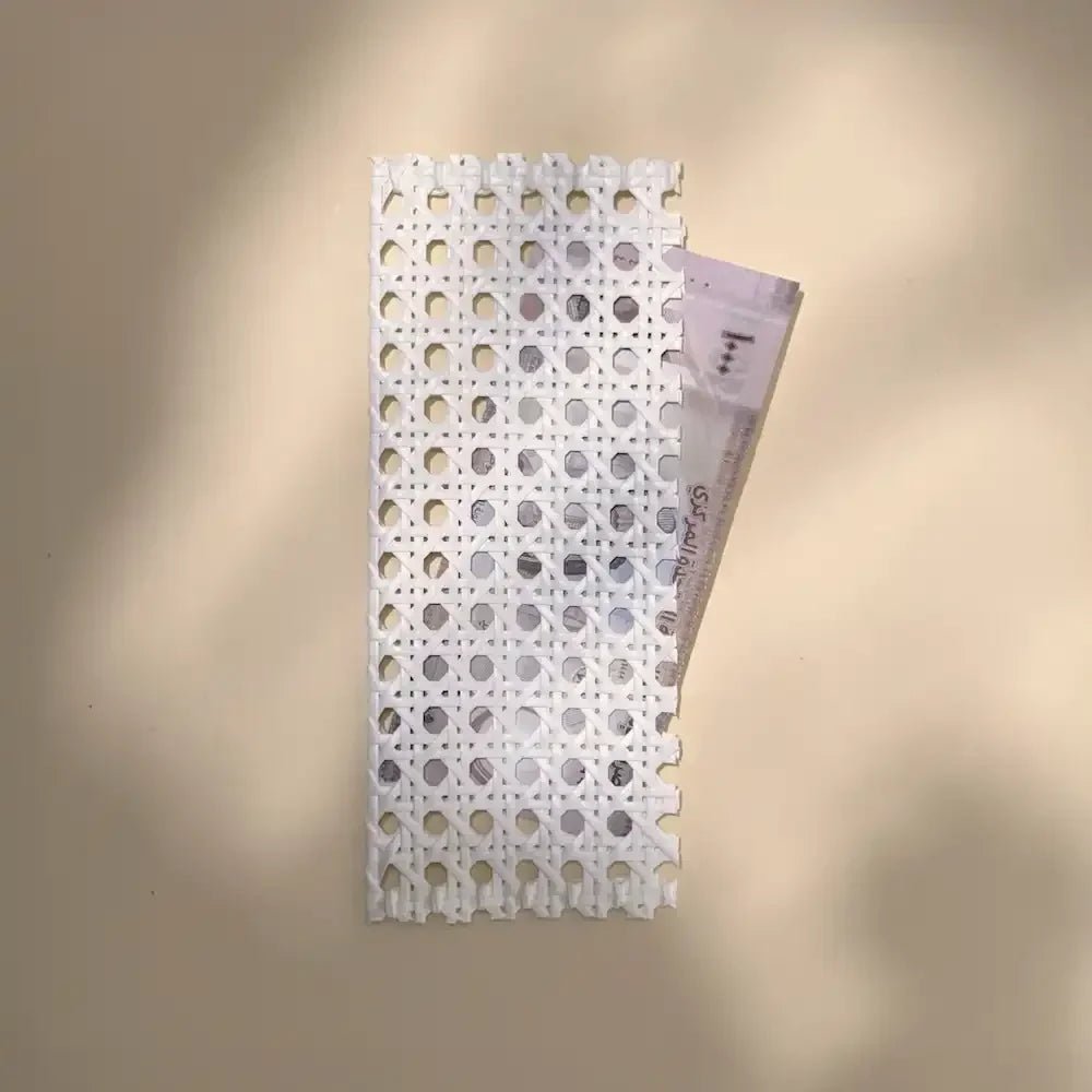 Rattan money pouch open to reveal a cash gift tucked inside, top angle
