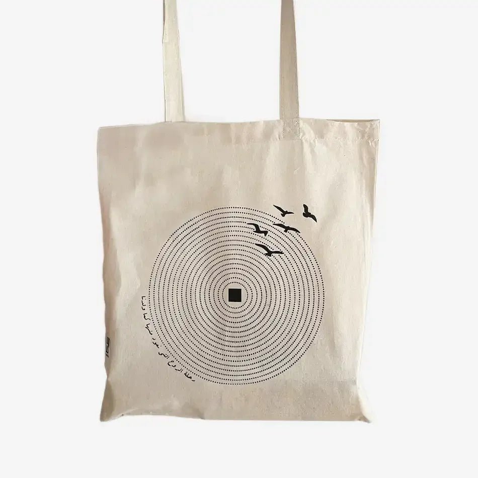 Natural canvas tote bag with circular dot pattern and flying birds print
