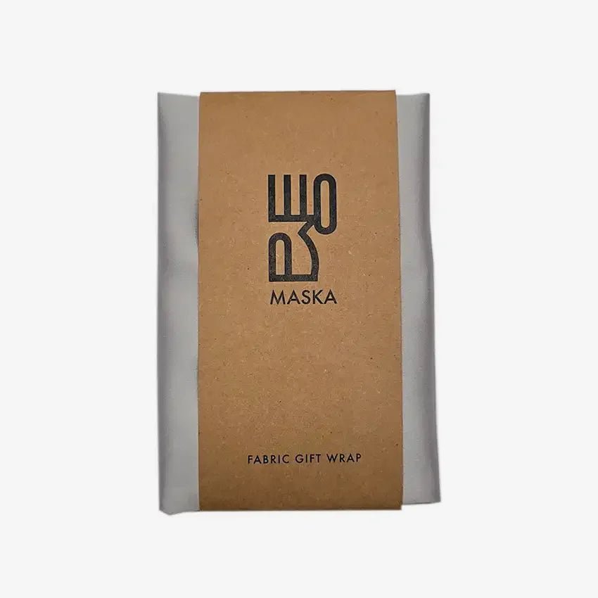 Silver satin gift wrap folded in kraft packaging band, front view