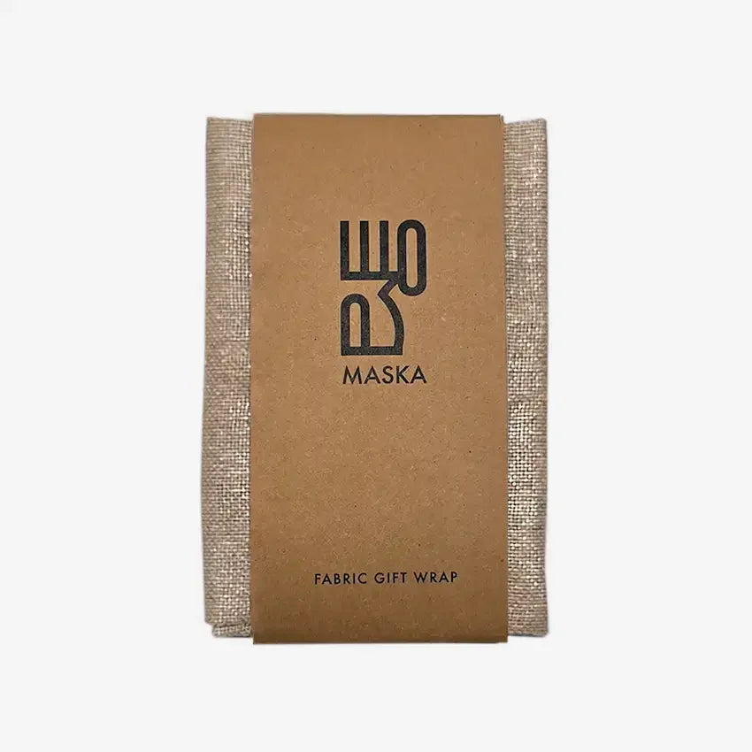 Khaki cotton linen gift wrap with silver foil, folded with kraft Maska band