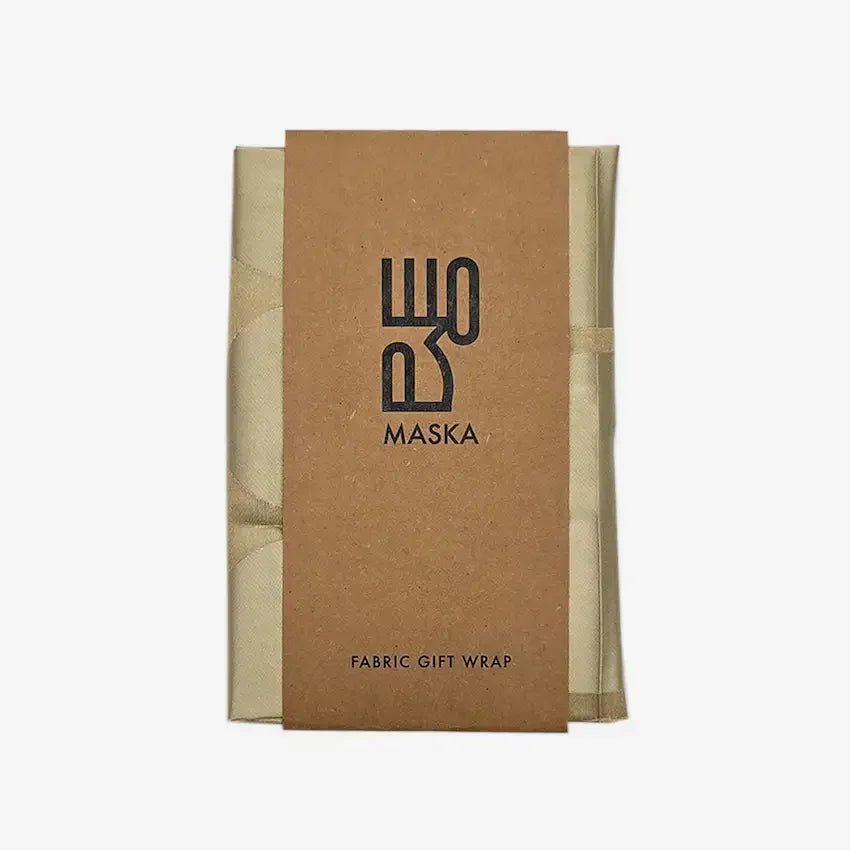 Folded sand jacquard fabric wrap with Maska kraft packaging band