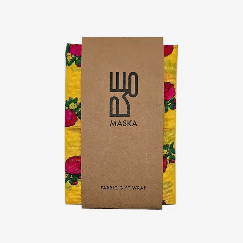 Yellow floral fabric wrap folded with Maska kraft paper band
