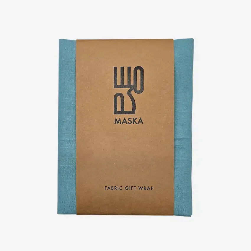 Folded tiffany blue cotton gift wrap with Maska kraft paper band, front view