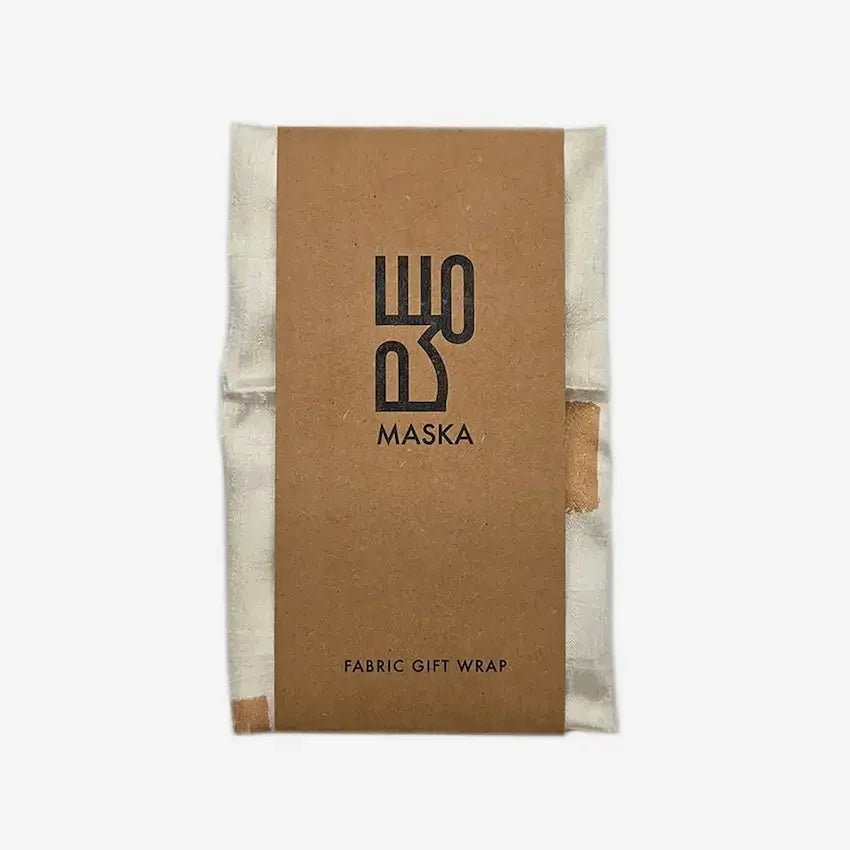 Folded gold dot fabric wrap with Maska kraft paper band packaging