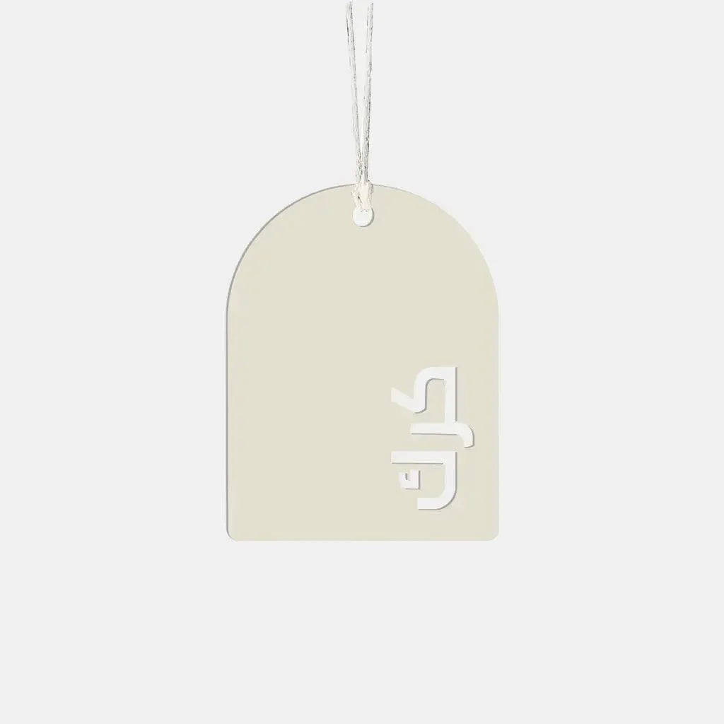 Arch-shaped cream gift tag with cut-out Arabic lettering and hanging string