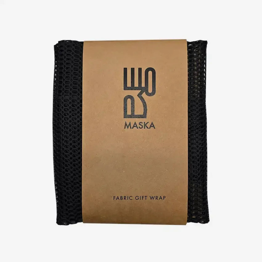 Black porous net gift wrap folded with Maska kraft paper band, front view