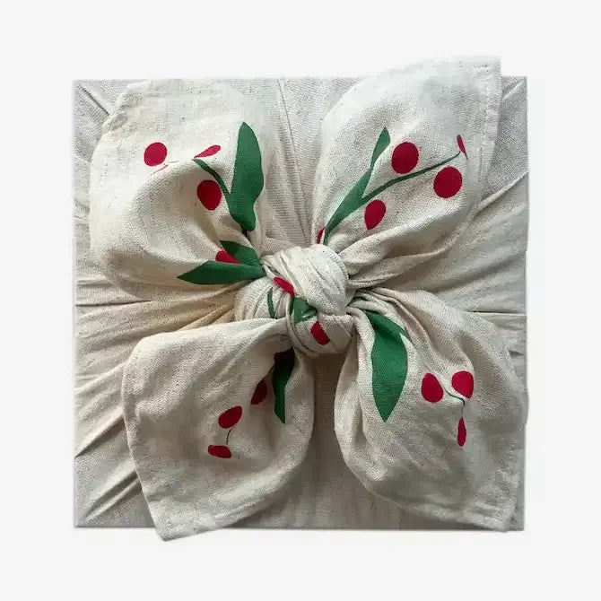 Calico fabric gift wrap tied in a bow, holly berry print, gift wrapped square parcel