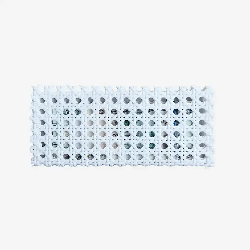 Flat lay of white woven rattan cash pouch showing open-lattice texture