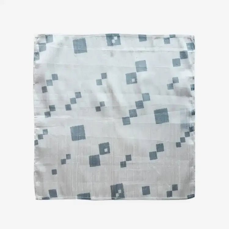 Silver diagonal dots fabric gift wrap laid flat, square furoshiki-style cloth