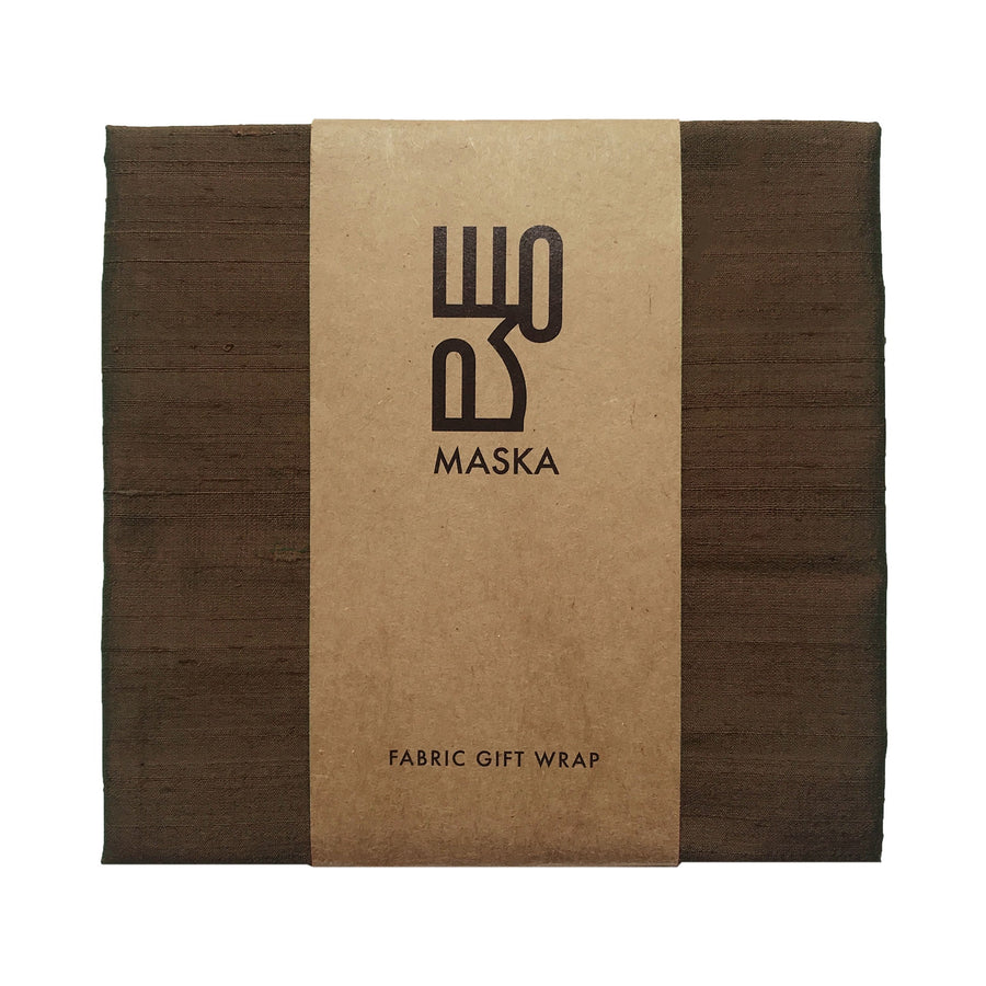 Dark bronze raw silk gift wrap folded with kraft paper band, front view