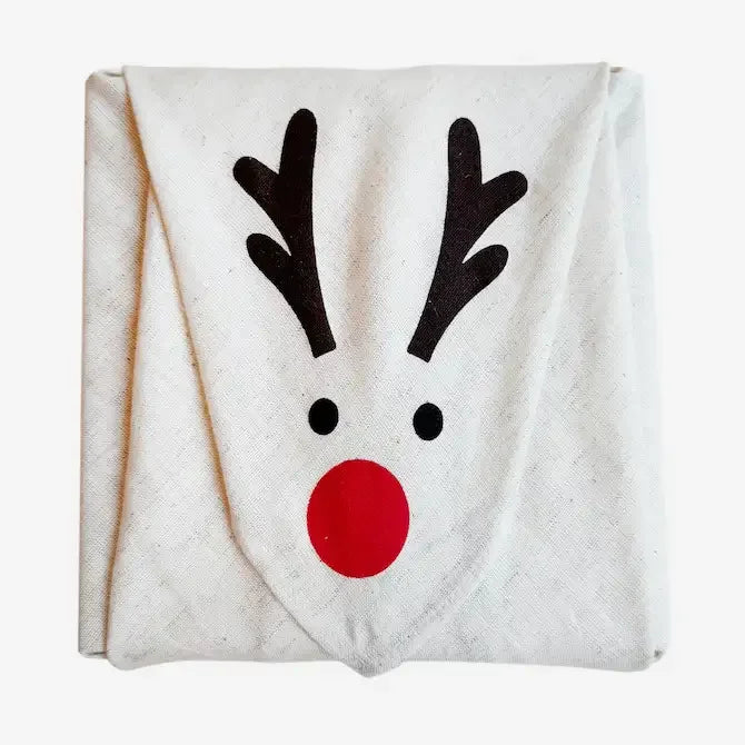 Folded calico fabric gift wrap with reindeer face print, red nose detail