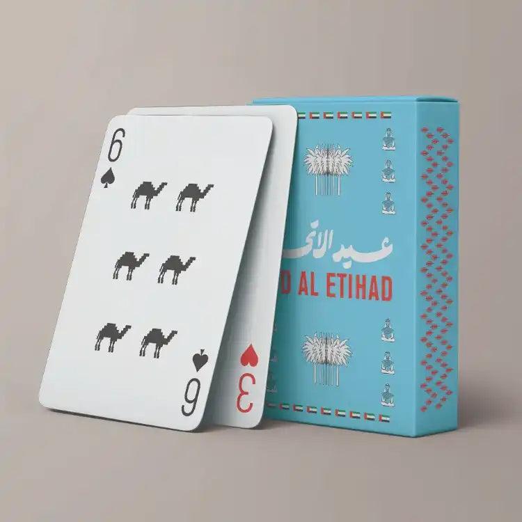 Eid Al Etihad playing cards box with camel-print card leaning beside it