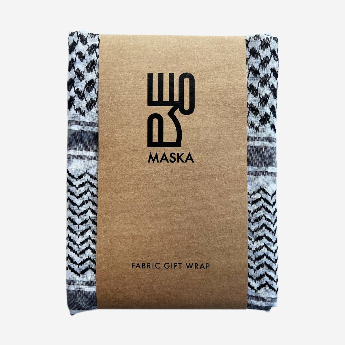 Black and white kufiya print fabric gift wrap folded in kraft packaging