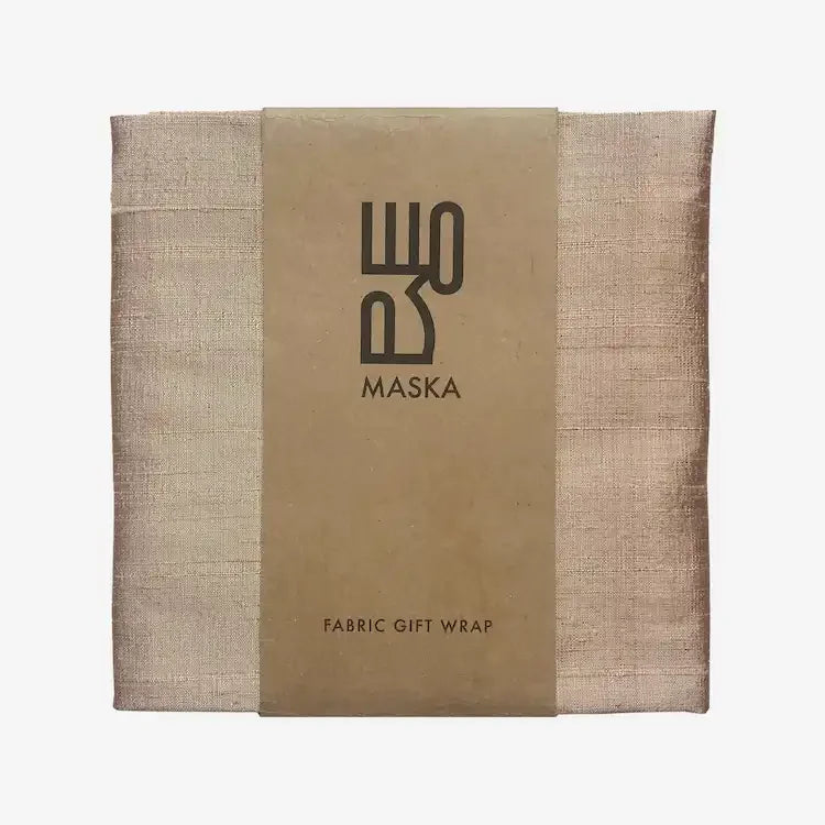 Folded light bronze raw silk gift wrap with Maska branded paper band
