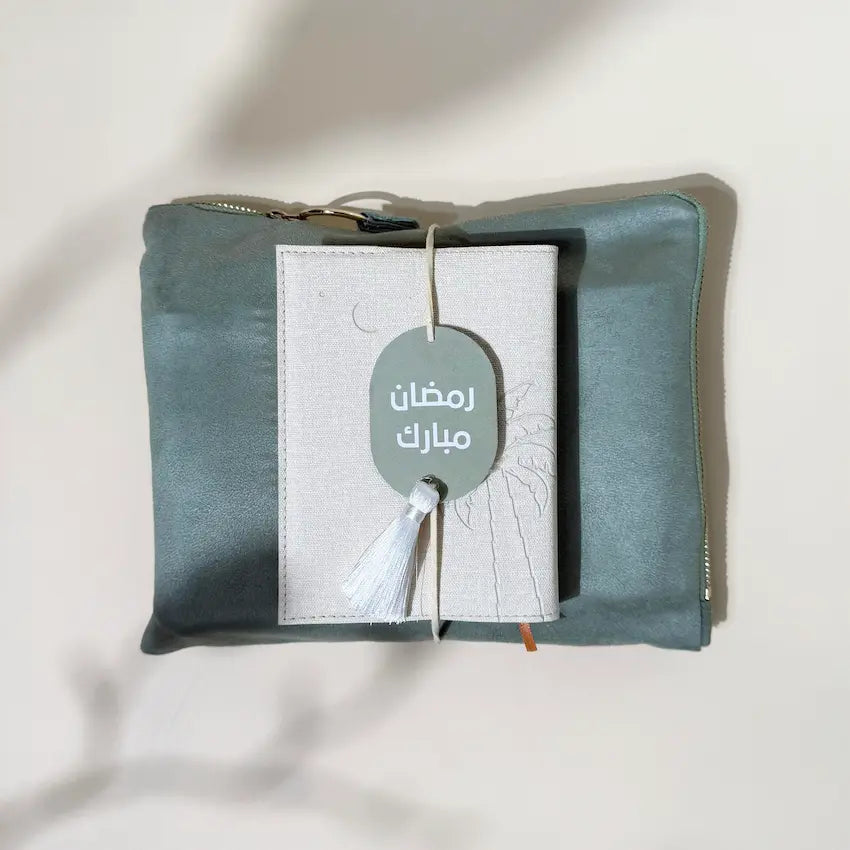 Folded prayer pouch with Quran and Ramadan Mubarak tag tied with tassel