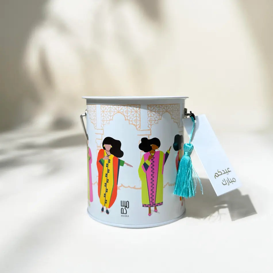 Metal gift can with dancing girls illustration and turquoise tassel, Eid Mubarak tag