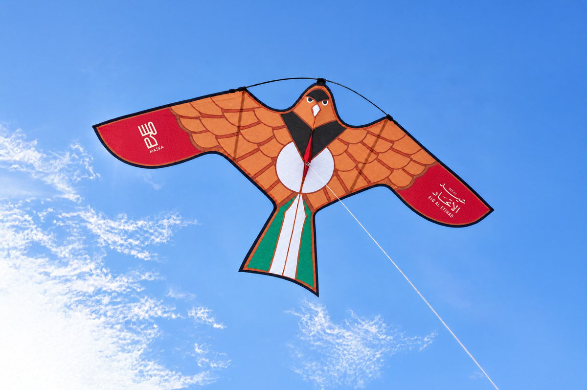 Eid Al Etihad falcon kite flying in a blue sky