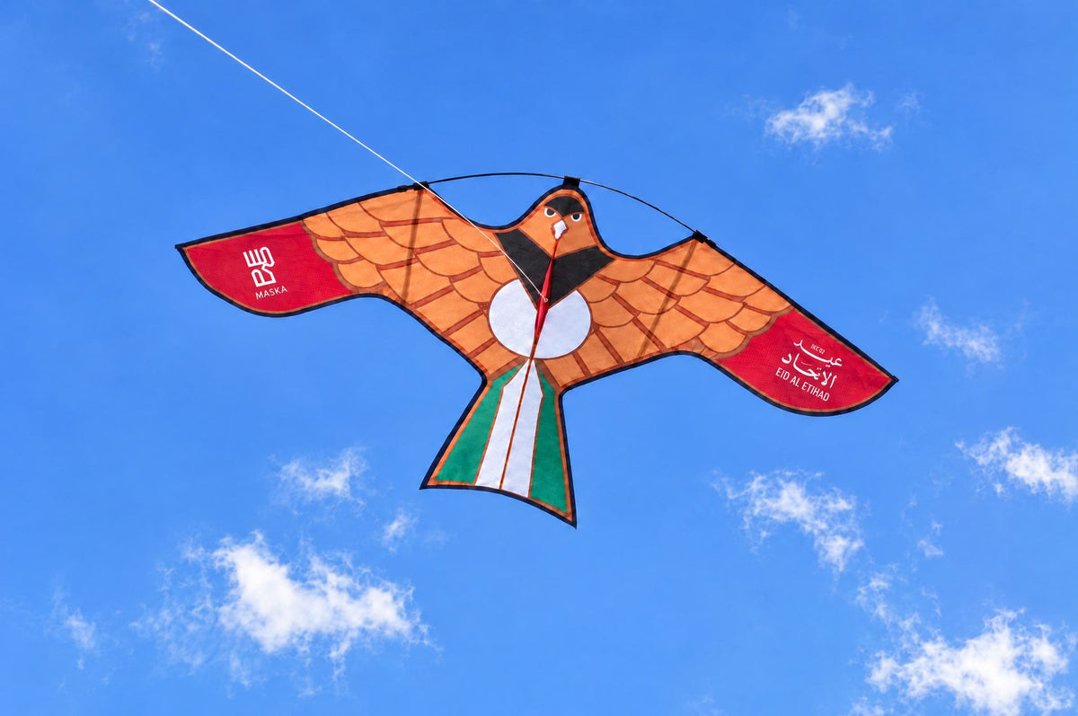 Eid Al Etihad falcon kite soaring above the clouds