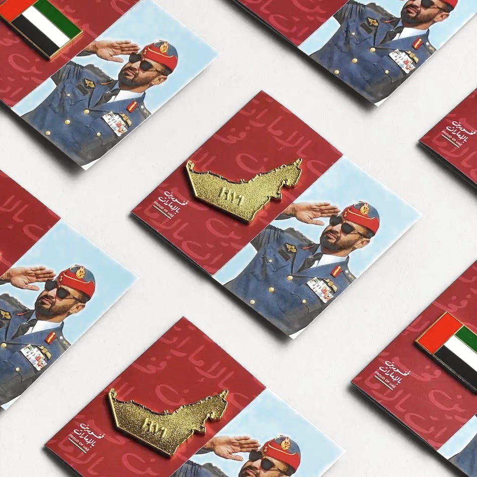 Proud of UAE pin cards on a white surface